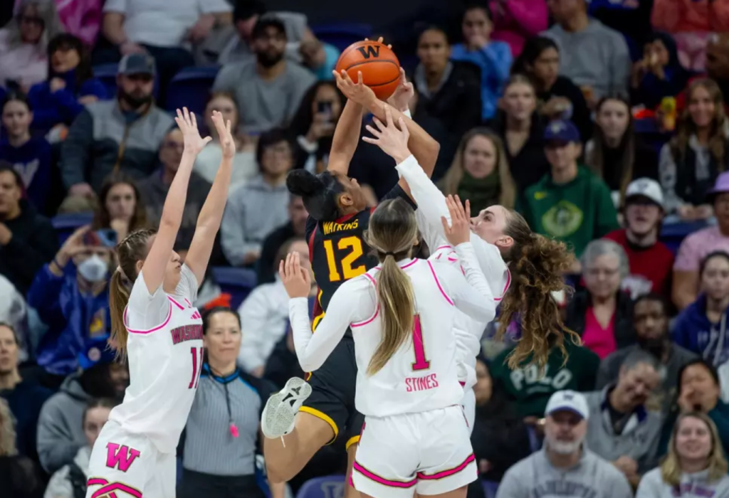 The University of Washington guards Chloe Briggs, Hannah Stines and Elle Ladine defend USC star JuJu Watkins on February 16, 2025 at Alaska Airlines Arena in Seattle, Wash.